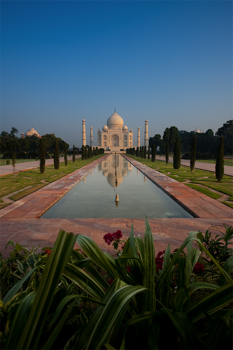 A distant view of the Taj Mahal at sunrise reflected in the first of two fountains. - Agra, Uttar Pradesh, India - Daily Travel Photos