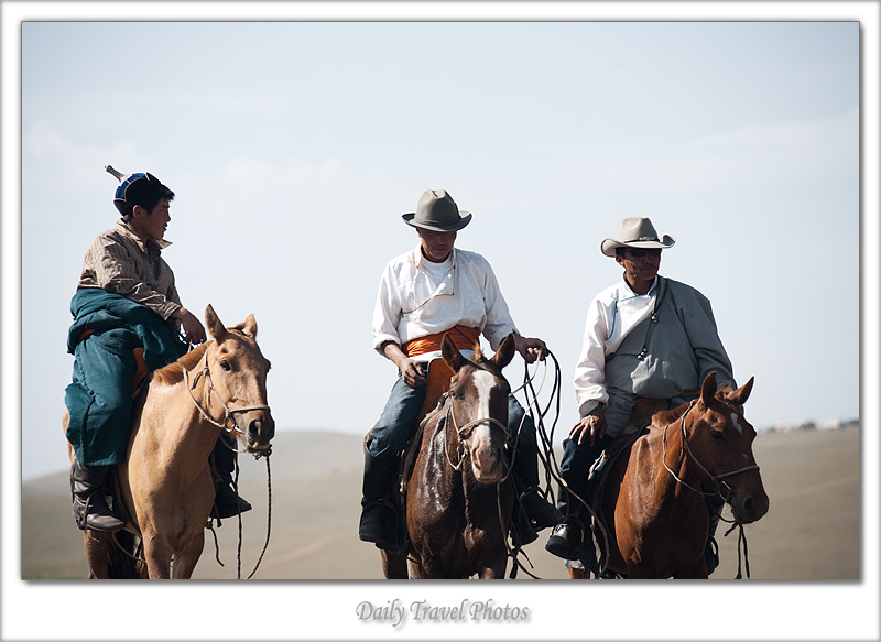 Mongolian cowboys on horseback in traditional clothes - Ulaan Baatar, Mongolia - Daily Travel Photos