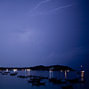 photo: Beach Light Show - Pattaya beach & resting songthaew (boats) partially illuminated by a bolt of lightning.  Of course this isn't the infamous Pattaya, a few hours from Bangkok.  It's a Pattaya beach on the small island paradise in the south of Thailand near Malayasia.