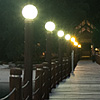 <i>Pulao</i> Piers Photo: A pier at dusk leading to a resort's reception desk.