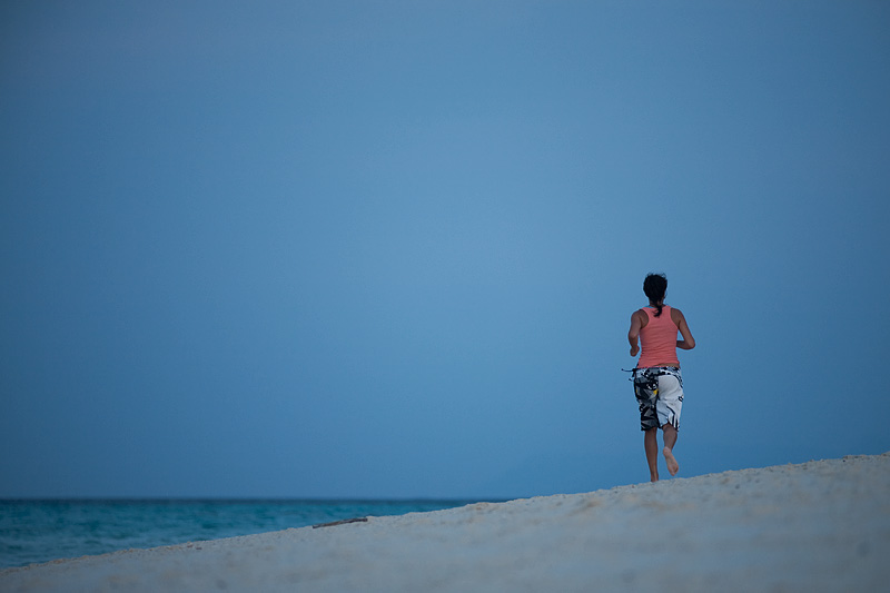 A vacationing jogger on Mountain Resort's beach. - Ko Lipe, Thailand - Daily Travel Photos