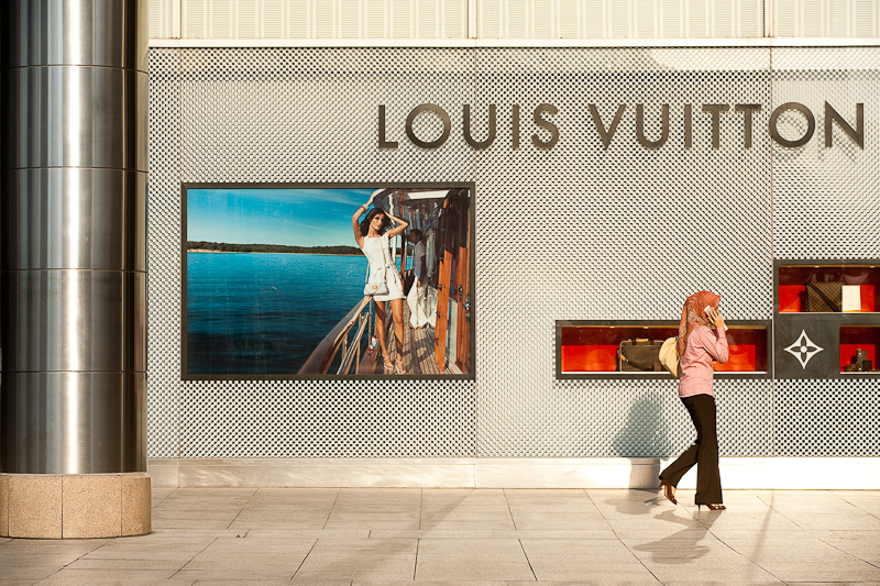 Along Ethnic Lines - An ethnic Malay woman walks in front of a Louis Vuitton  store. - Kuala Lumpur, Malaysia - Daily Travel Photos - Once Daily Images  From Around The World 