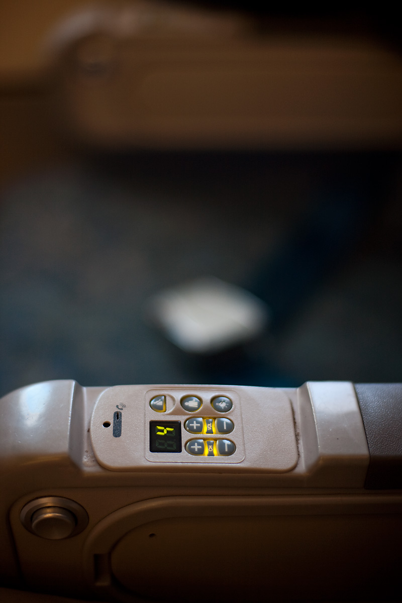 An airplane armrest displays the channel number and various buttons for a TV that doesn't exist. - Airplane, Kuala Lumpur <-> London - Daily Travel Photos