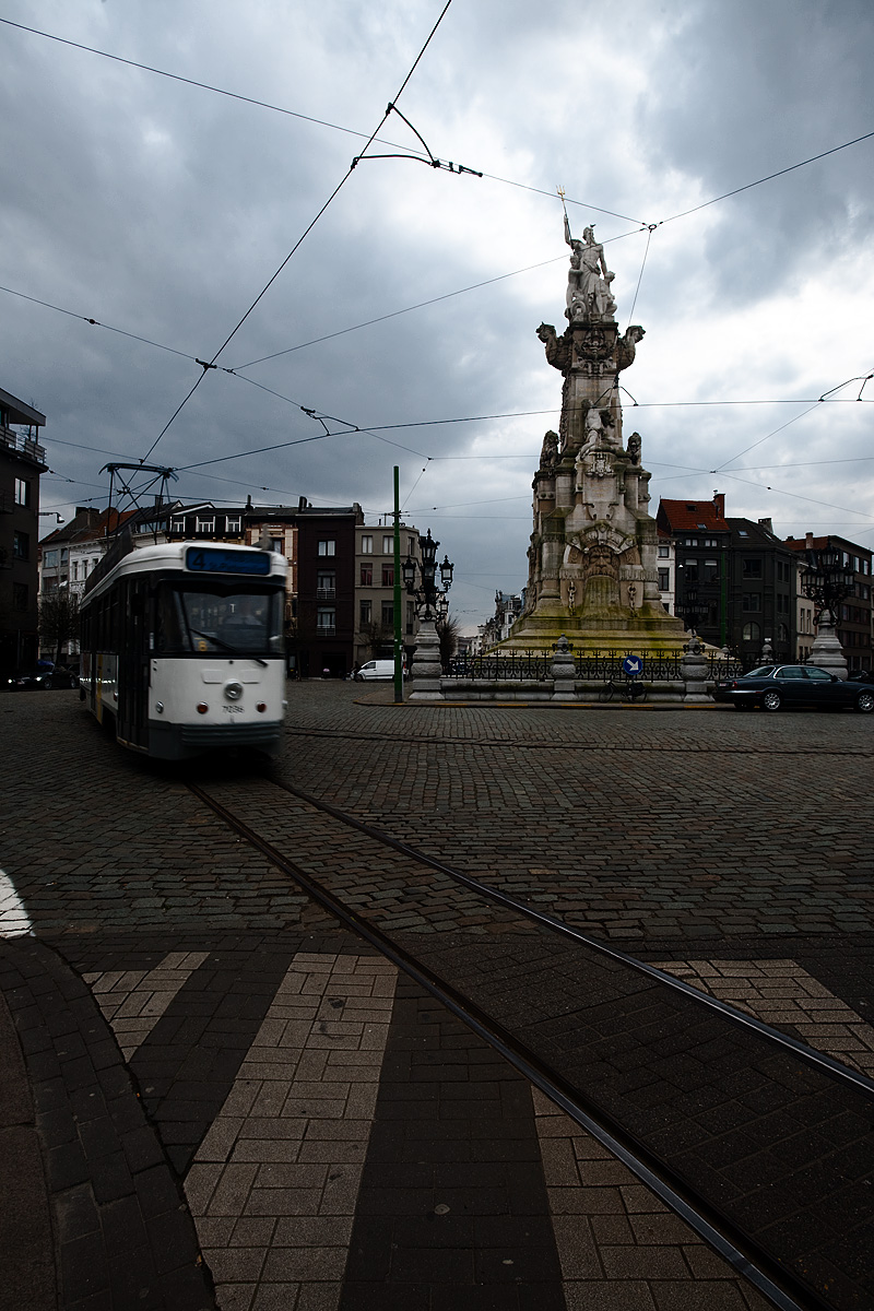 The number 4 tram drives around the center statue at Marnixplaats. - Antwerp, Belgium - Daily Travel Photos