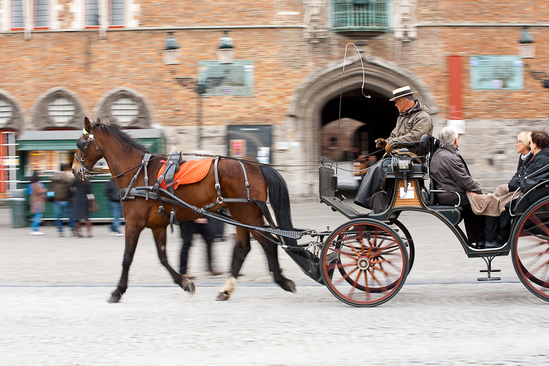 A tourist horse and buggy glide past the belfry on Grote Markt. - Brugge, Belgium - Daily Travel Photos