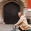 Saddlebags Photo: Panned photo of a bicyclist in front of Grote Markt's belfry.