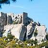 Rocky Ruins Photo: Mountain castle ruins framed by trees in Les Baux de Provence.