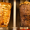 Shaved Meats Photo: Chicken and lamb shawerma meats rotate on a skewer.