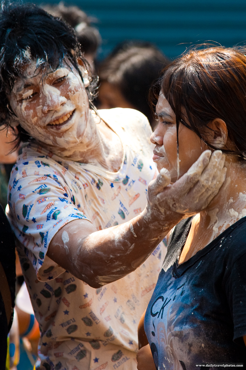 Songkran Thai New Year Guy Applies White Talcum Powder Paste On Girl - Bangkok, Thailand - Daily Travel Photos
