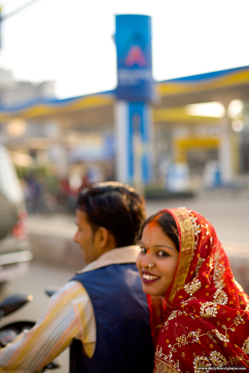 Indian Bride Gives Smiling Glance Riding Pillion on Motorcycle - Varanasi, Uttar Pradesh, India - Daily Travel Photos