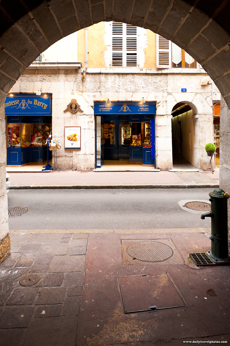 Storefront in Old Town Through a Beautiful Ancient Arch - Annecy, Haute-Savoie, France - Daily Travel Photos