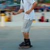 Vientiane Evening Recreation Photo: A moving pan of a Laotian inline-skater on the promenade at sundown in Vientiane.