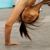 Capoeira Clap Photo: An athletic Thai woman performs a back handspring during a capoeira exhibition at Central World mall in Bangkok.