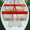 Hourly Hire Photo: Red rowboat ready for hire on Annecy Lake.